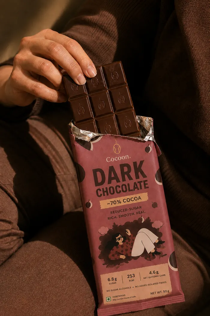Squares of Cocoon dark chocolate on cocoa powder